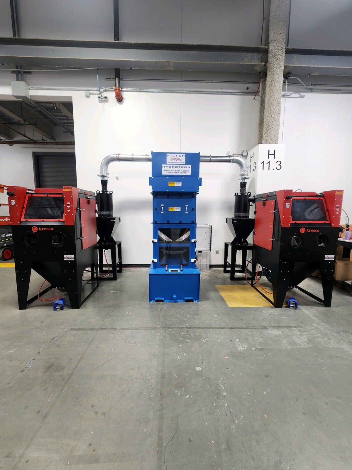 Customer installation: two Kresco PowerBlast PB3636S suction blast cabinets with cyclone reclaimers ducted to a central wet dust collector